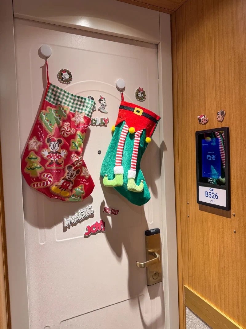 Cruise cabin door decorated with Christmas stickers and stockings