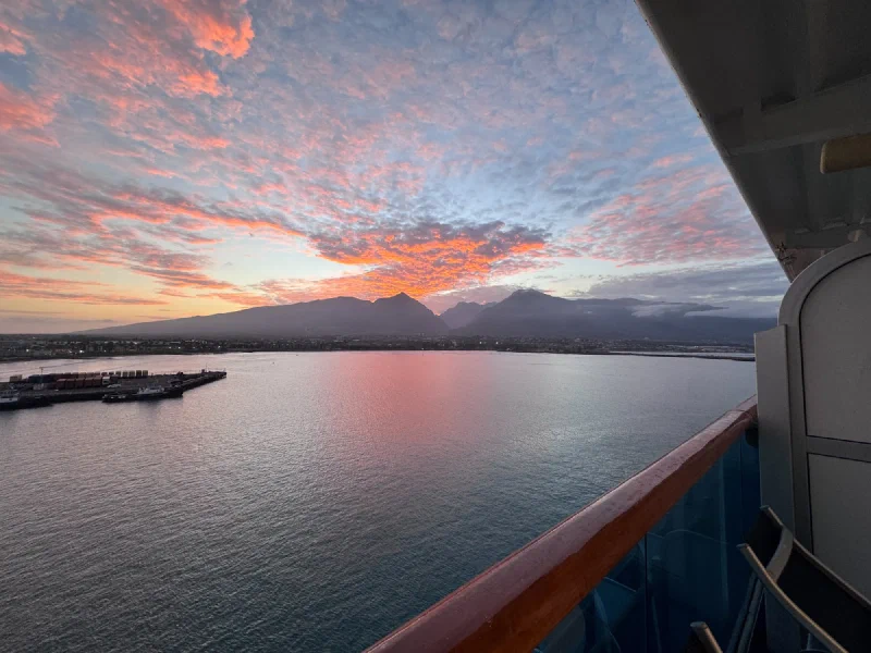 Sunset over Kahului harbor from the cruise ship balcony with mackerel sky