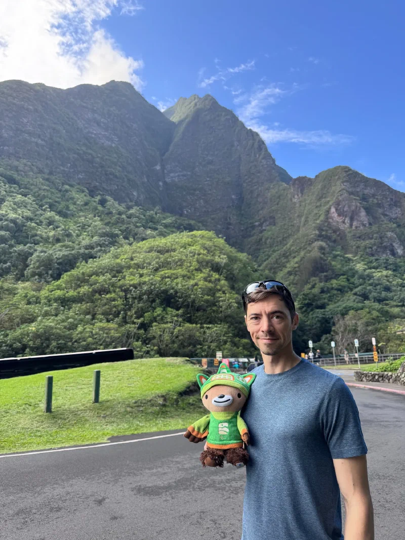Nicholas holding Sumi at the base of Iao Valley mountains in Maui