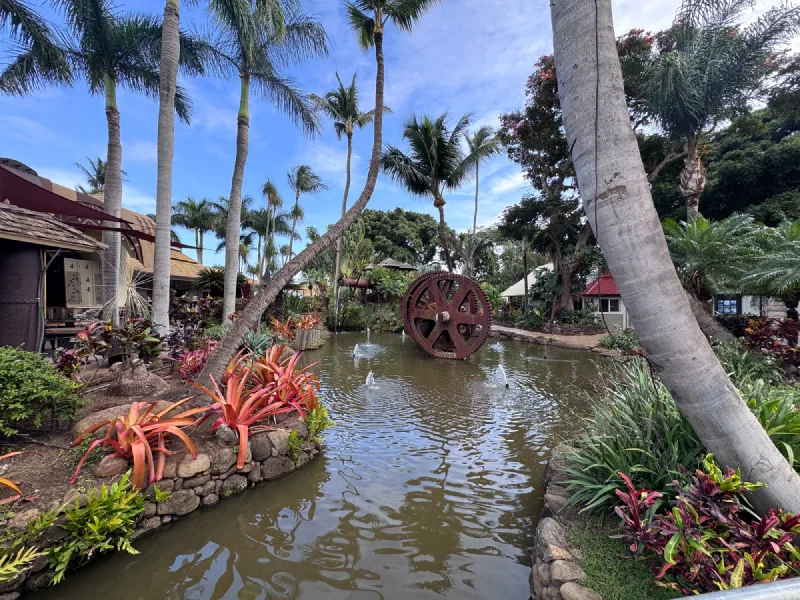Tropical garden with old water wheel and pond at a Maui plantation