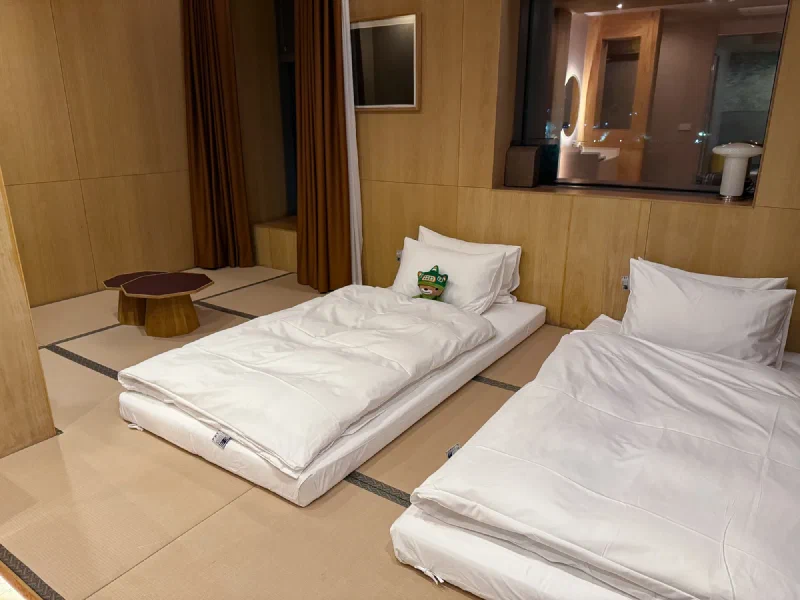 Traditional Korean hotel room with Sumi tucked into bed