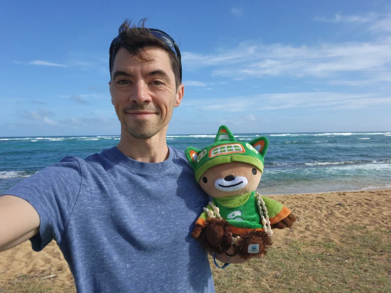 Nicholas holding Sumi on the beach