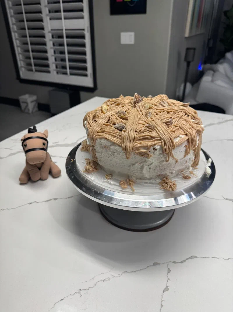 Chestnut the plush horse next to a chestnut cake