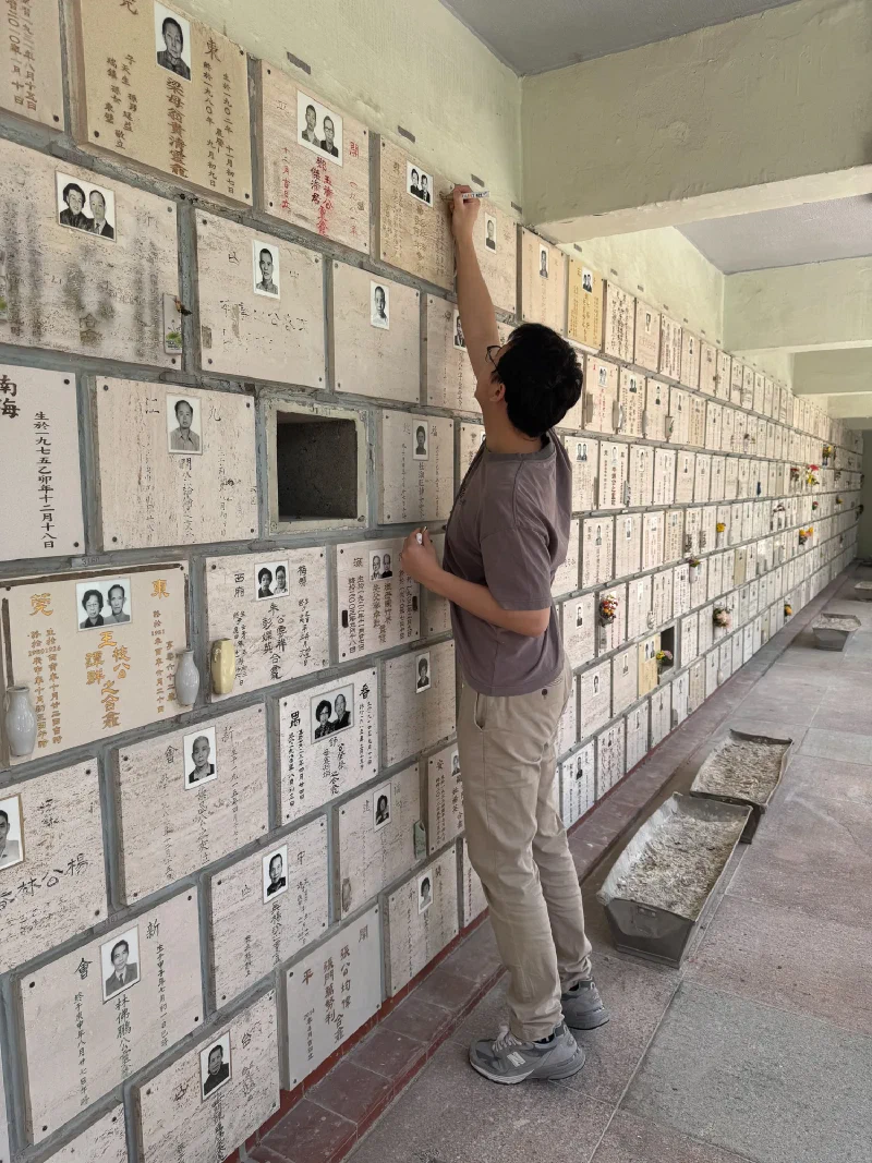 Pokong cleaning an ancestor's niche at Cape Collinson