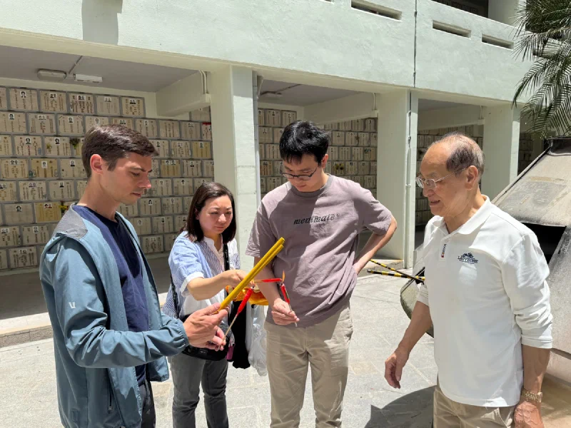 Family holding incense at Cape Collinson
