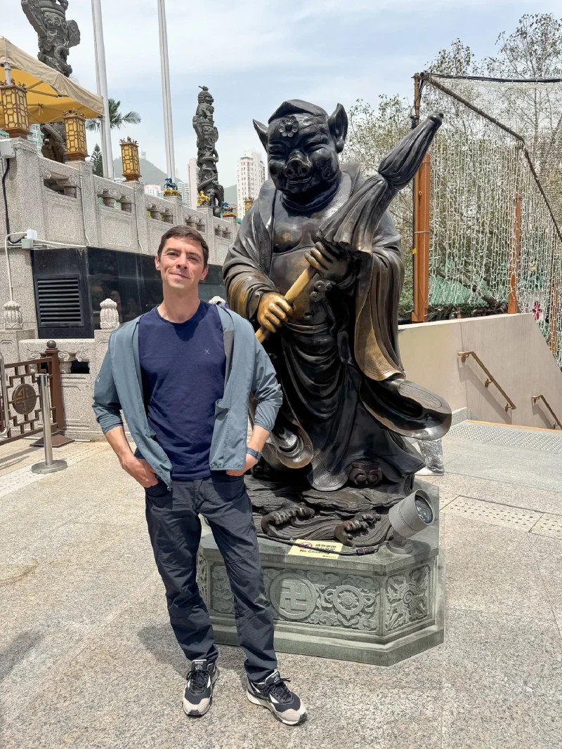 Nicholas posing with the Pig zodiac statue at Wong Tai Sin Temple