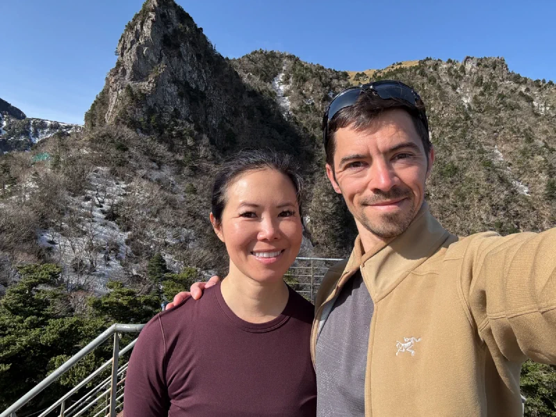 Nicholas and Pokin selfie with the dramatic rock spire behind them