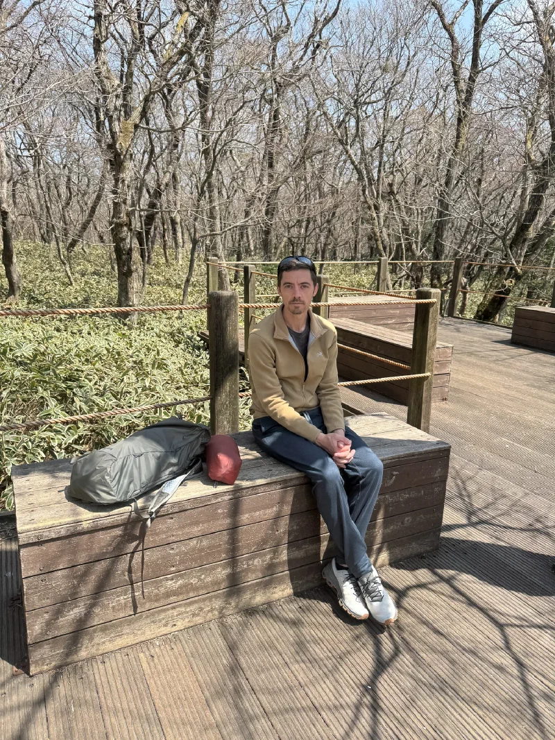Nicholas resting on a bench along the trail
