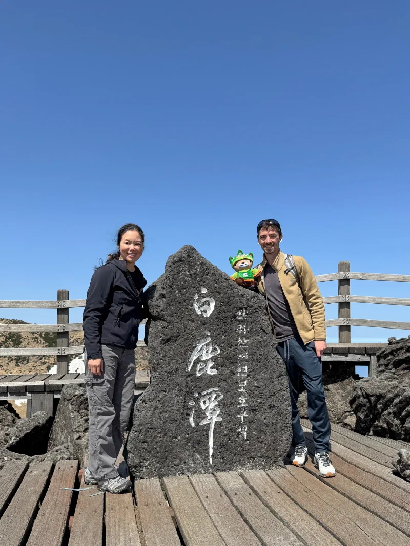 Nicholas and Pokin at the Baengnokdam summit stone with Sumi on top
