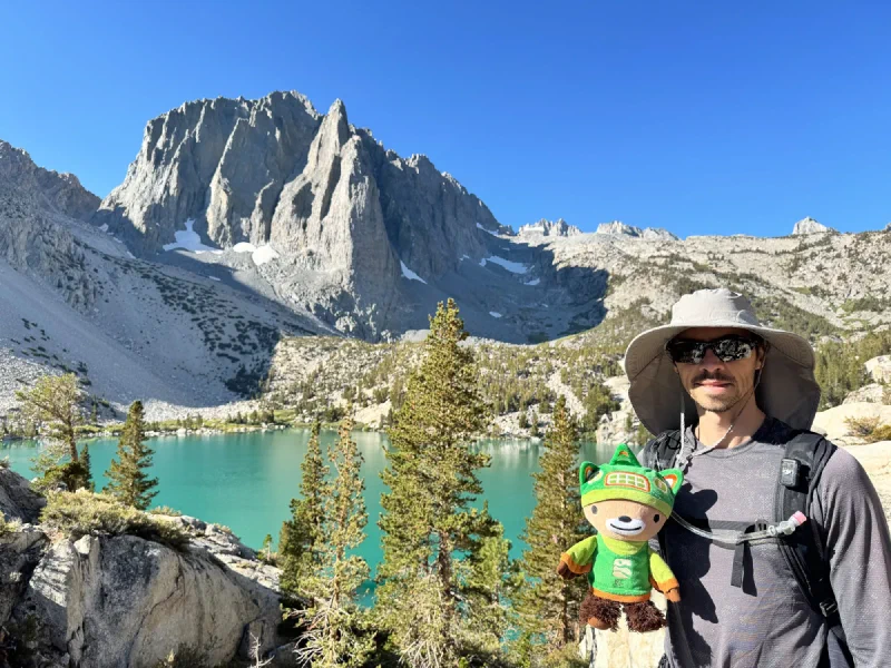 Nicholas holding Sumi with Temple Crag and turquoise lake