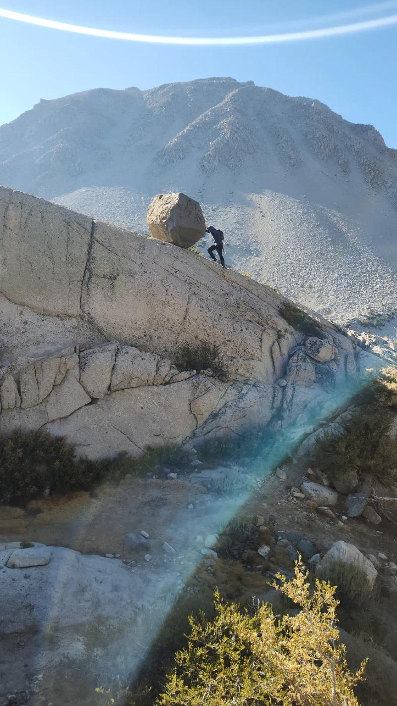Bruce pretending to push a giant boulder