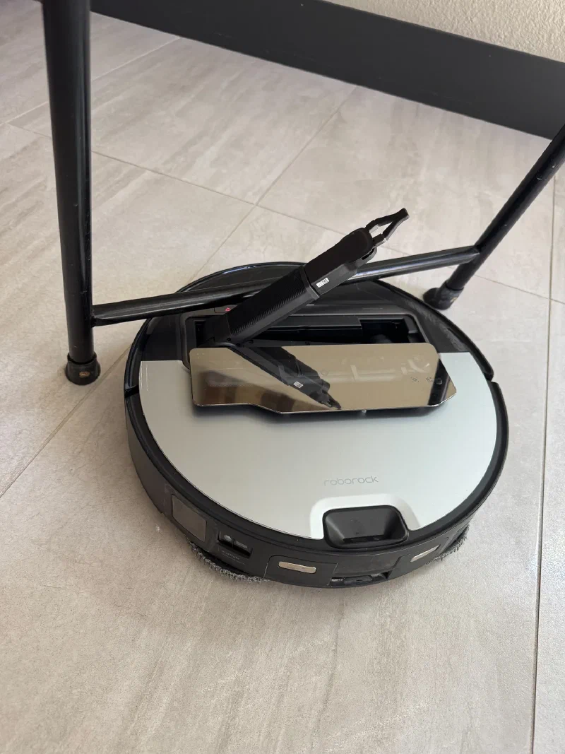 Roborock stuck under a table with its arm raised