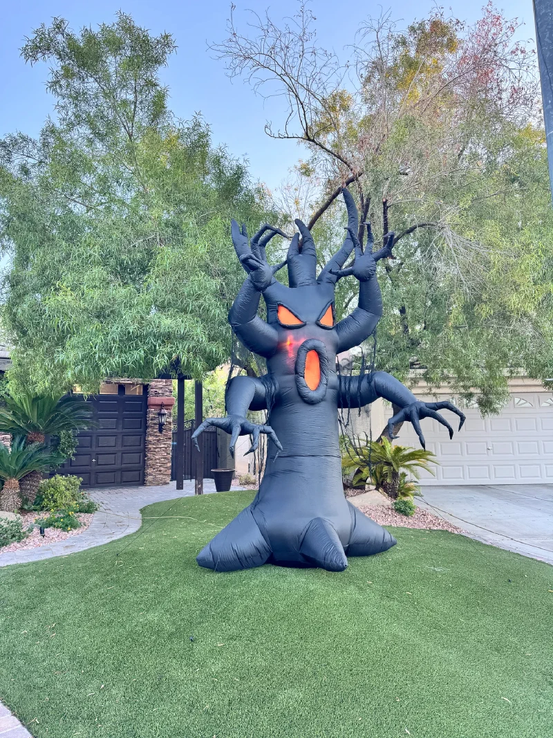 Giant inflatable Halloween tree with screaming face in the yard
