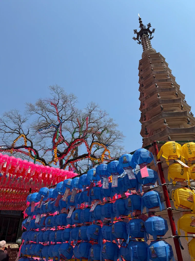 Stone pagoda surrounded by prayer lanterns at Jogyesa Temple