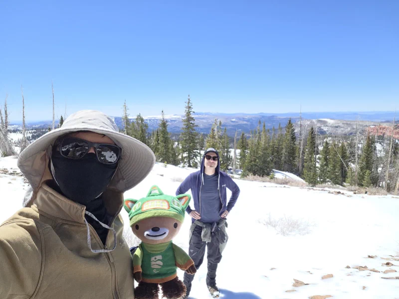 Eric and Sumi on a snowy mountain trail during the Brian Head Peak training hike