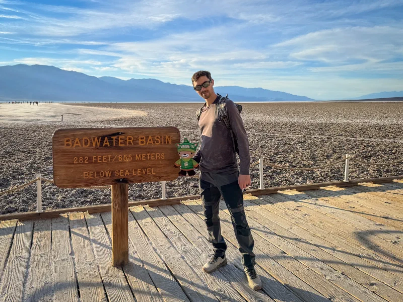 Sumi Bear sitting on top of the Badwater Basin sign showing 282 feet below sea level