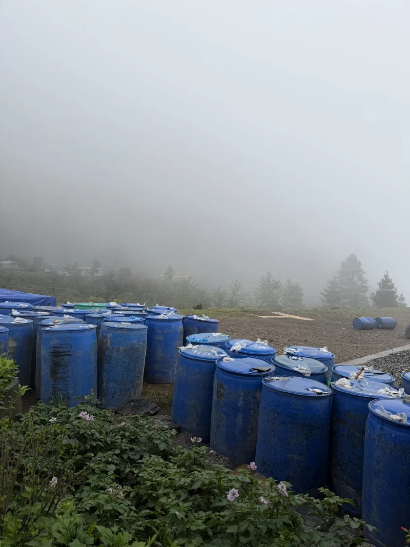 Looking out at the foggy helipad with blue barrels, no helicopter, very thick fog