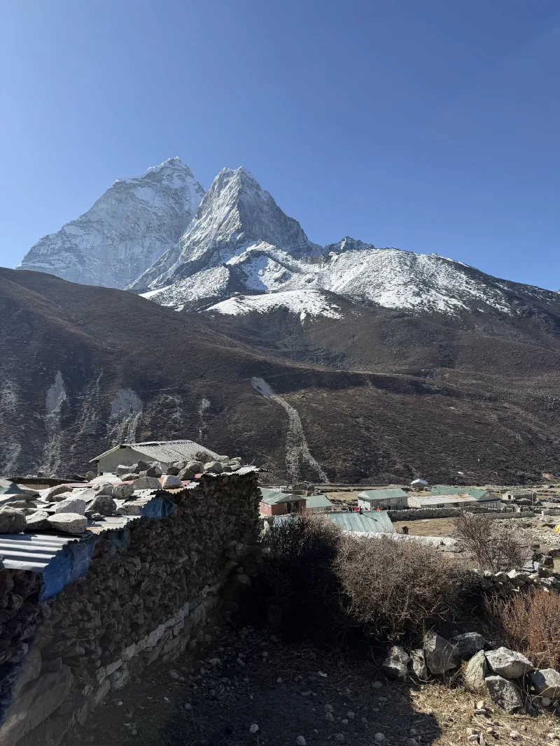 Ama Dablam seen from Dingboche over stone walls