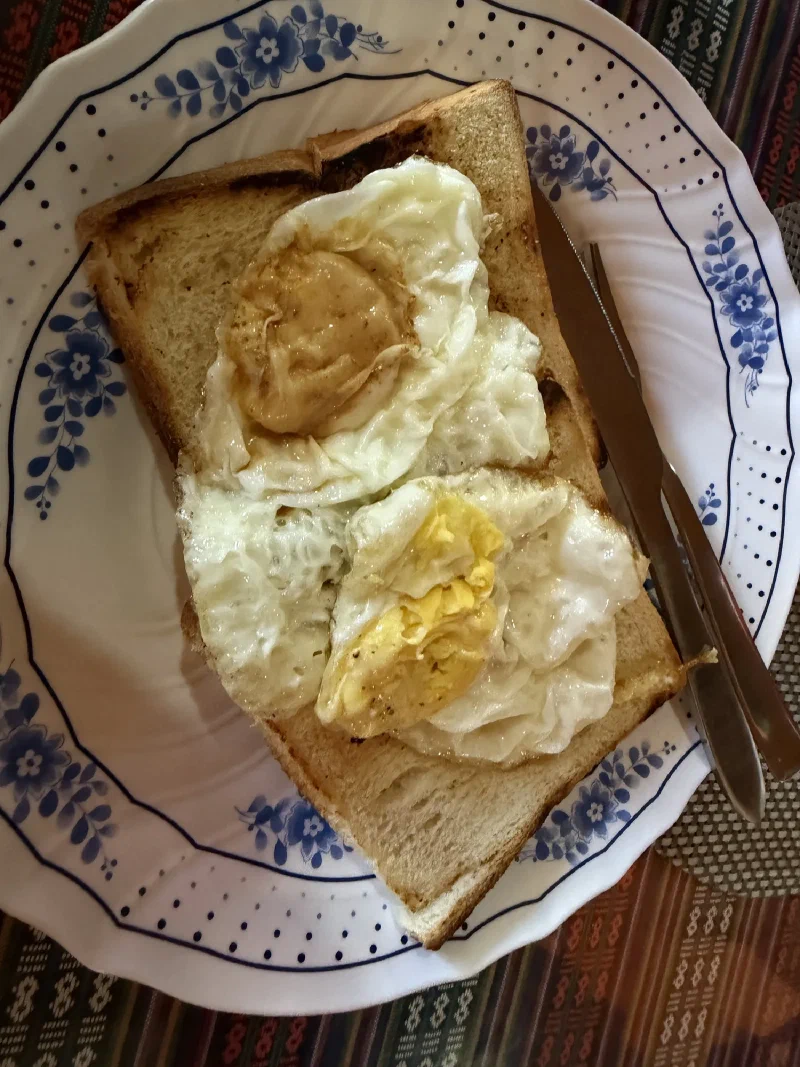Fried eggs on toast on a blue-rimmed plate