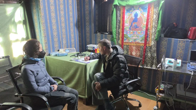 Pokin being examined by a doctor at the Mountain Medical Institute in Dingboche