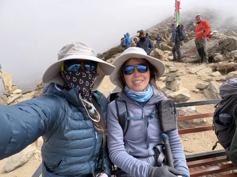 Pokin and Po On selfie at a viewpoint with prayer flags