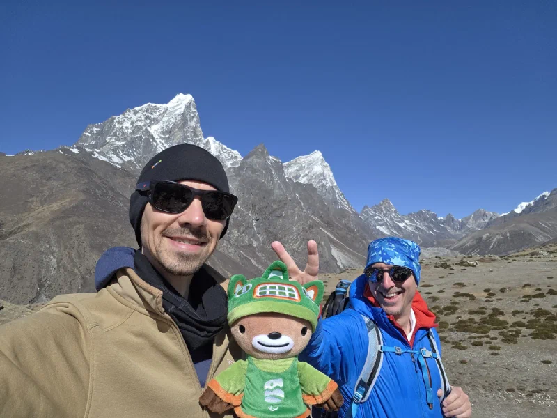 Nicholas holding Sumi with Steve giving bunny ears behind