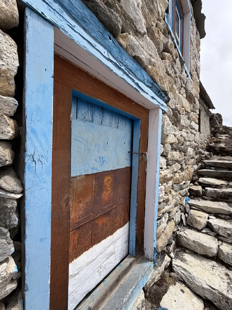 Stone building door with blue frame