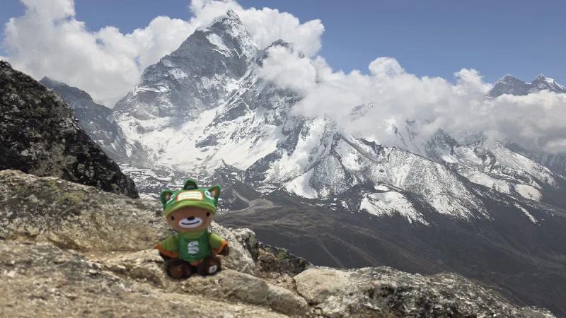 Sumi on a rock with Ama Dablam behind
