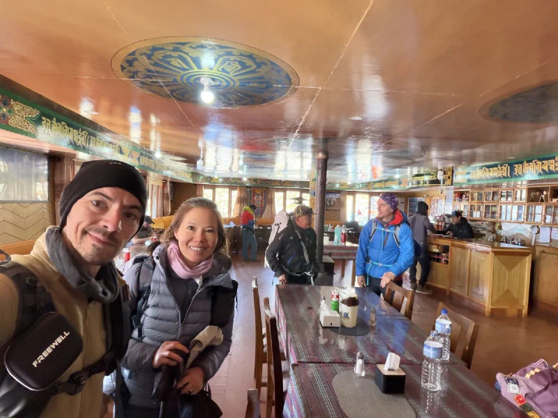 Nicholas and Pokin selfie in the lodge dining room with ornate mandala ceiling