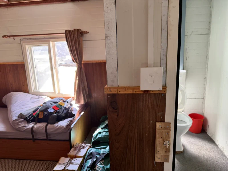 Room layout showing bedroom and bathroom doorway