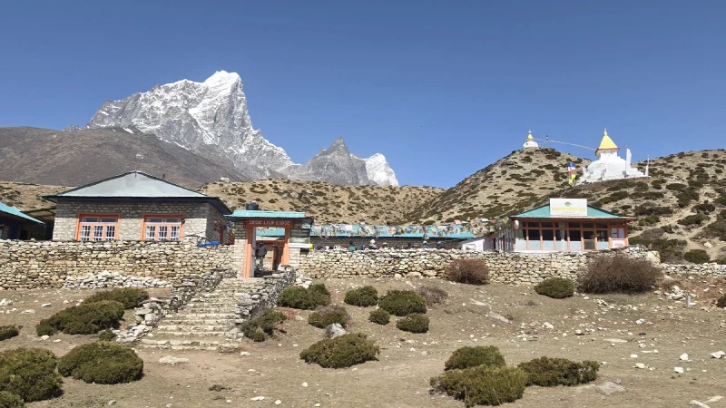 Snow Lion Lodge and French Bakery Cafe in Dingboche with stupas on the ridge