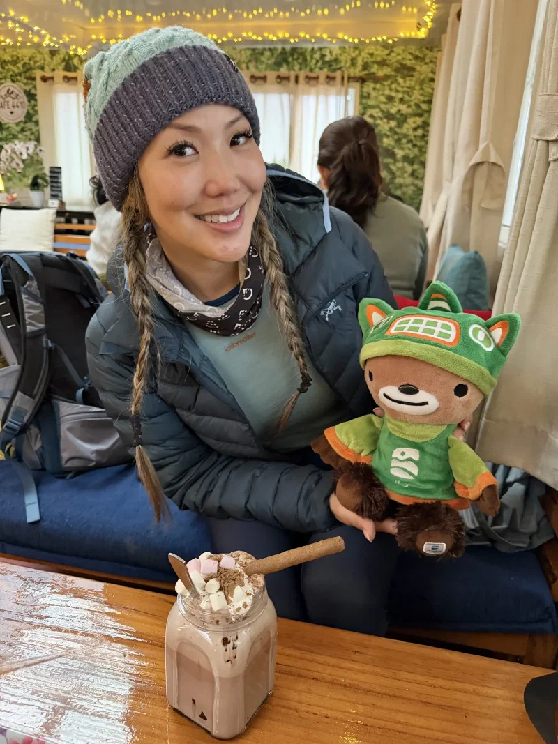 Po On holding Sumi at Cafe 4410 with an elaborate hot cocoa topped with marshmallows and whipped cream