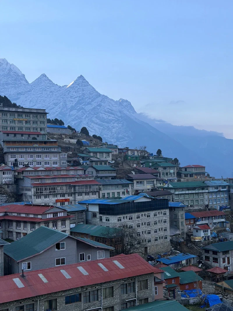 Namche lodges stacked up hillside with Kongde Ri peaks catching first sunlight