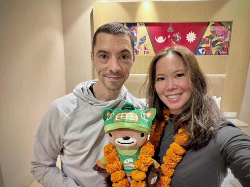 Nicholas and Pokin with Sumi wearing a marigold garland