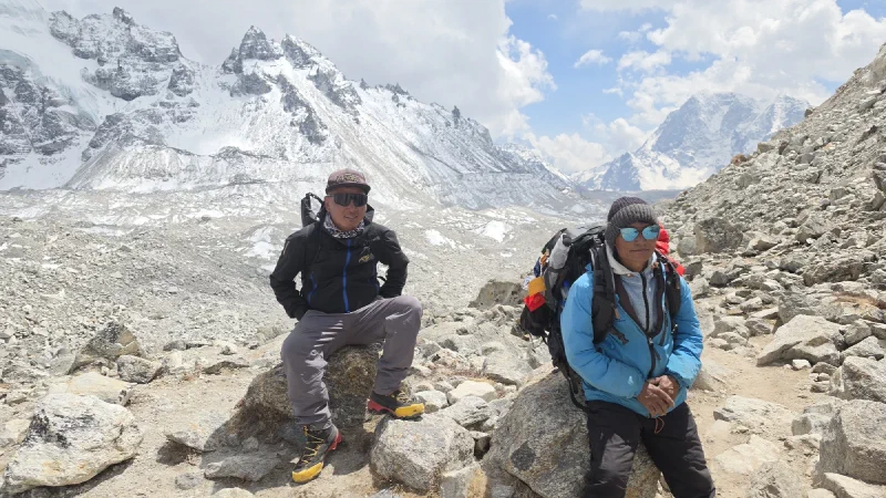 DB and Kerman resting on rocks along the trail