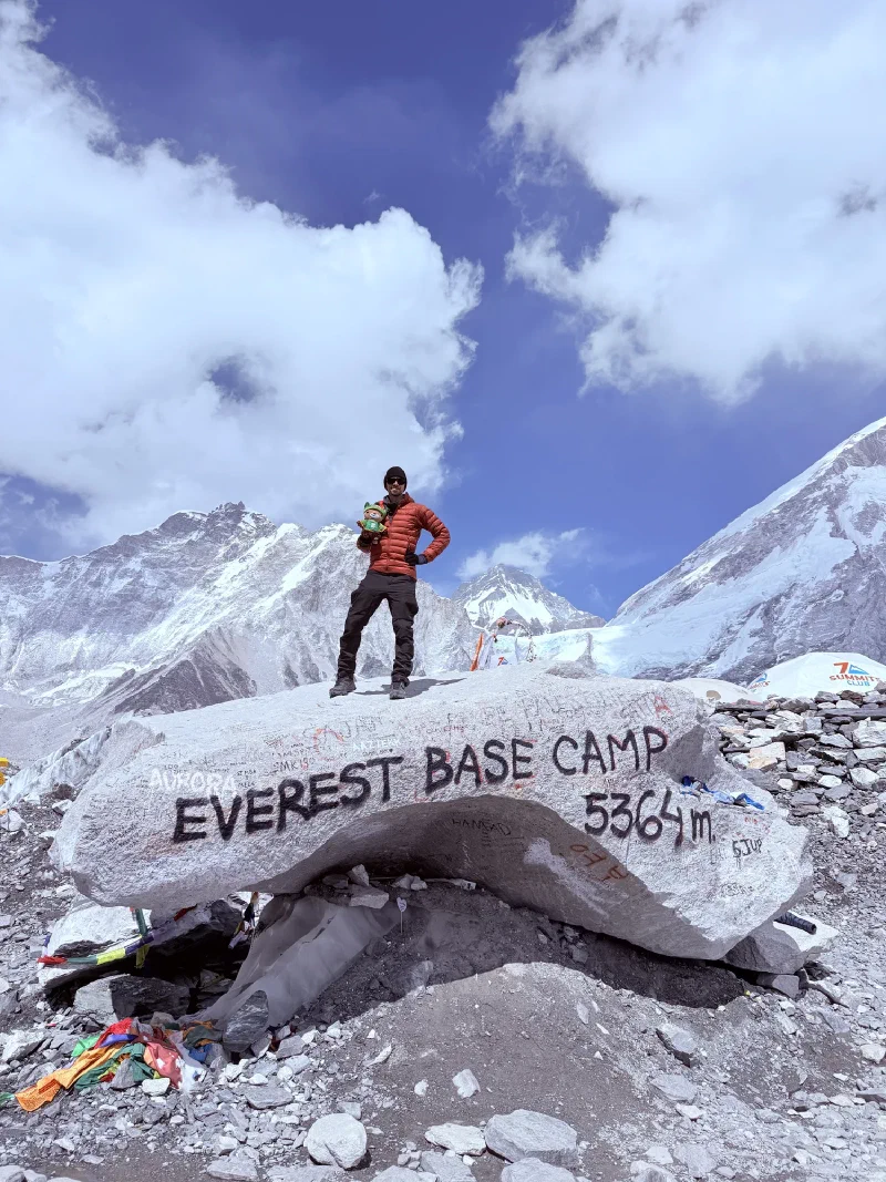 Nicholas holding Sumi on the famous Everest Base Camp rock