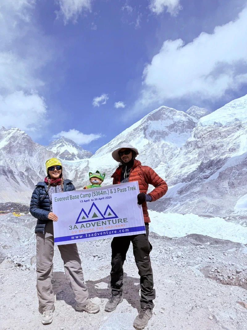 Po On, Nicholas, and Sumi posing with 3A Adventure banner at EBC