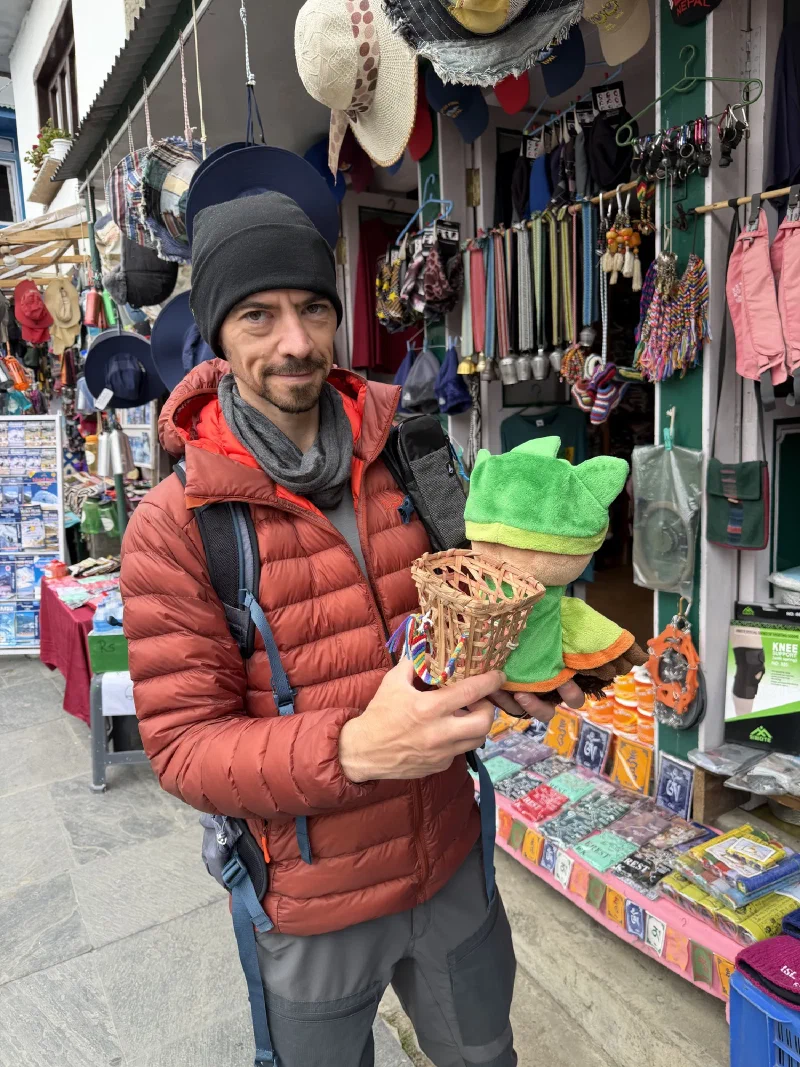 Nicholas holding up a small woven doko basket next to Sumi for size comparison