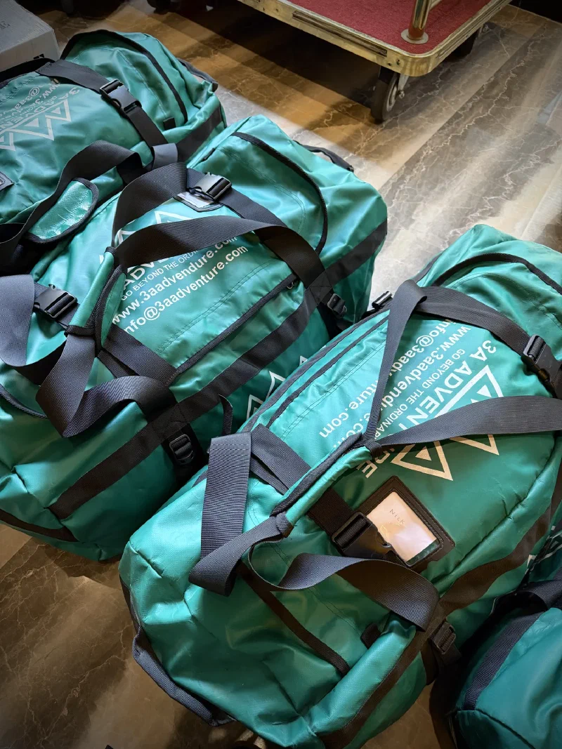 Close-up of 3A Adventure duffel bags with NICK luggage tag