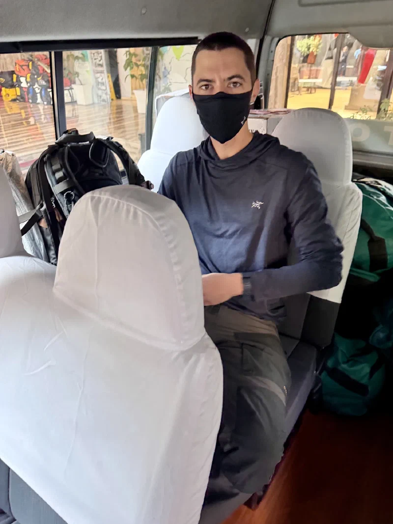 Nicholas sitting in the shuttle van heading to the airport