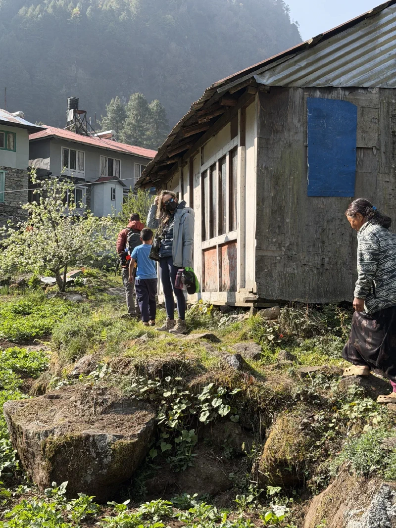 Phakding village homes with corrugated roofs and small vegetable gardens between stone buildings