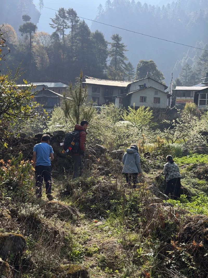 Walking through terraced farmland and village homes after the wrong helicopter drop