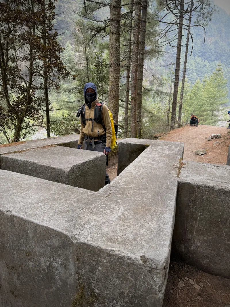 Nicholas standing inside a concrete yak barrier on the trail
