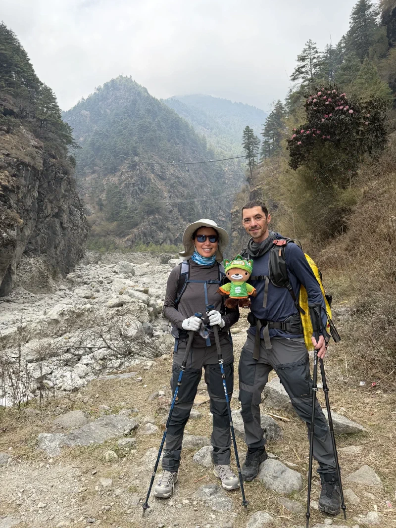 Nicholas and Alice posing before the bridge with both Hillary suspension bridges visible in the background