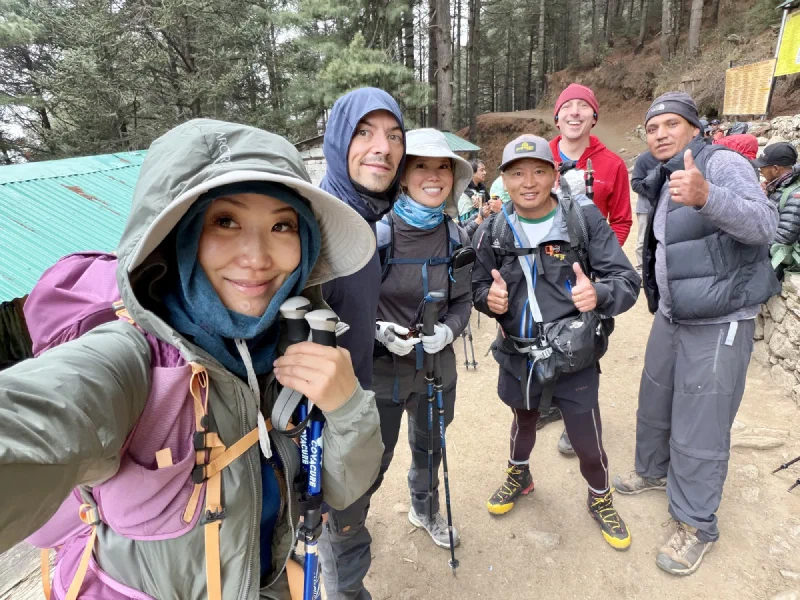 Group selfie rest stop during the climb through pine forest