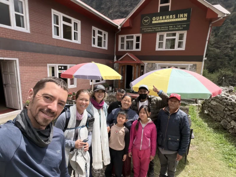 The Gurkha Inn family and trekkers posing outside the lodge