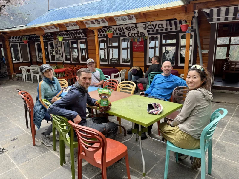 Group sitting at the Kailash Lodge drink stop with Sumi on the table