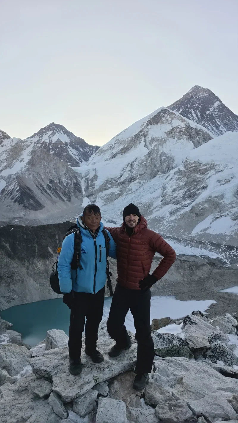 Nicholas and Kerman posing together on the summit with Everest behind