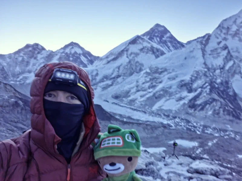 Nicholas and Sumi selfie at the summit of Kala Patthar before dawn with Everest behind