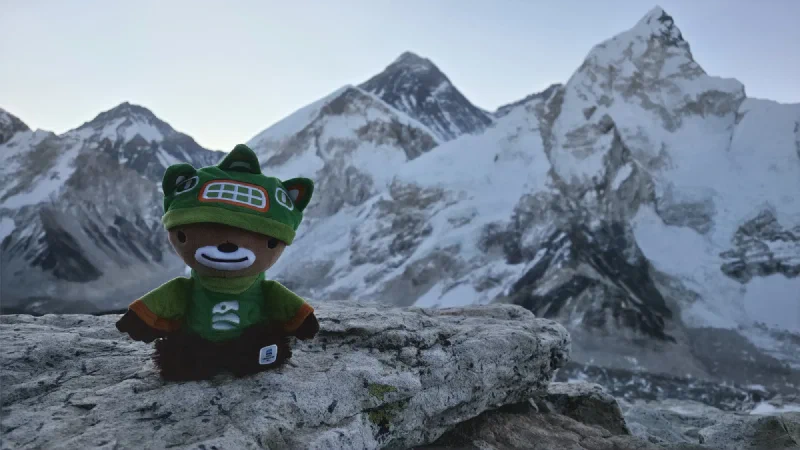 Sumi sitting on a rock with Everest in the background